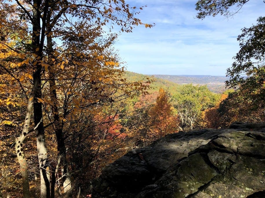 Rocky overlook through trees with red and yellow leaves