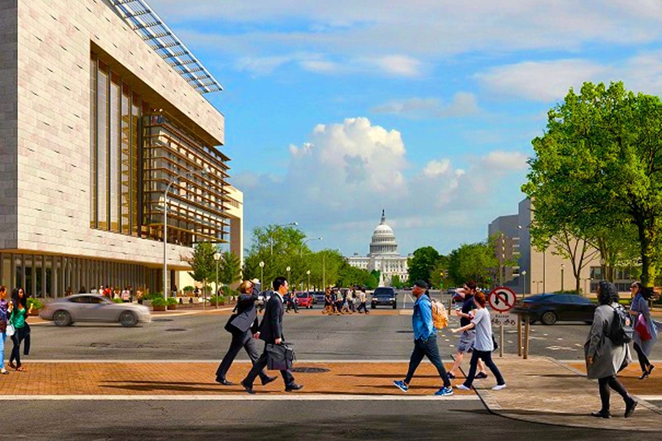 people crossing the street in front of 555 Penn with the Capitol in the background