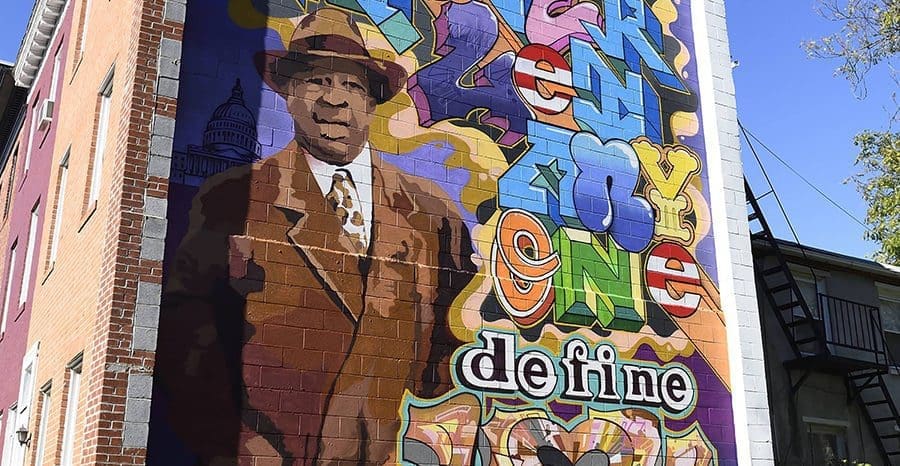 colorful painting of Elijah Cummings on the side of a building
