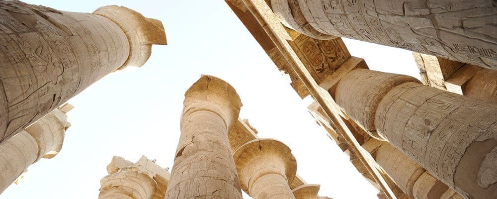 dramatic upward view of columns from ruins in Egypt