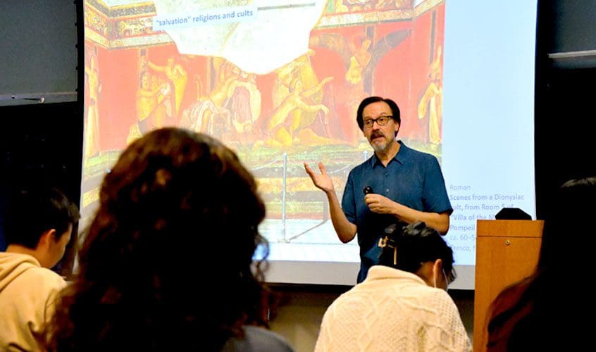 Professor Mitch Merback at lecturn teaching an undergraduate class for the course "Introduction to Art History". Location: Gilman Hall 132, David P. Nolan Room.