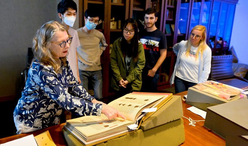 Professor Nino Zchomelidse and undergrad students reviewing manuscripts and books for the course, "Knowledge, Holiness, and Pleasure: The Illustrated Book in the Medieval World." Location: Richard Macksey Room in Brody Learning Commons.