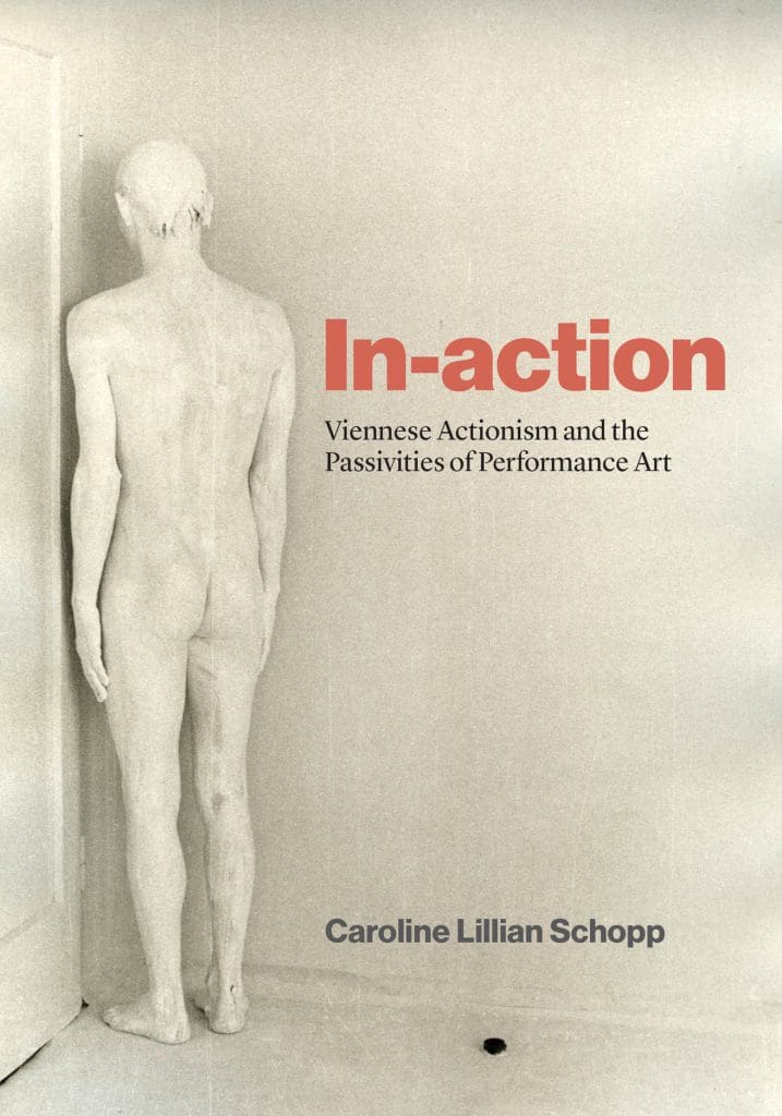 Book cover featuring a monochromatic image of a male sculpture from behind, with red and black text.