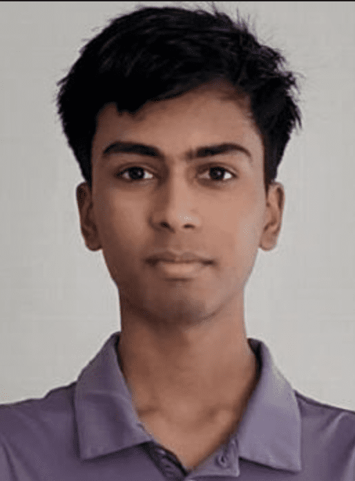 aditya looking into the camera in a gray polo shirt