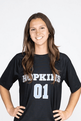 steph smiling with her hands on her hips in a JHU jersey