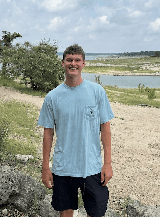 will smiling in a blue t shirt on the shore