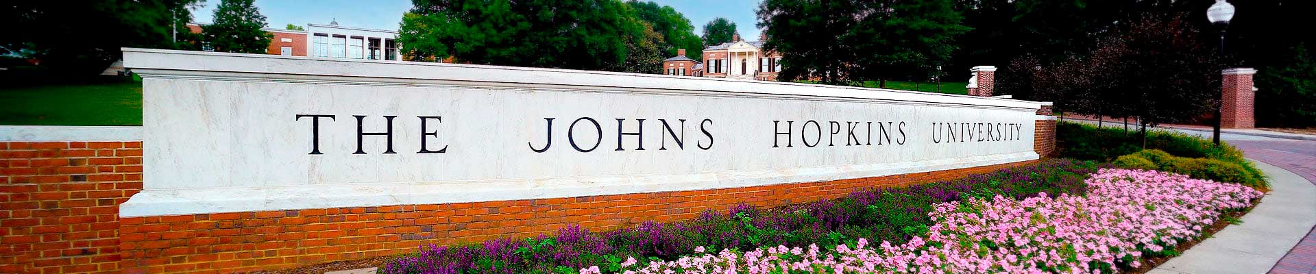 Johns Hopkins University sign with flowers in front