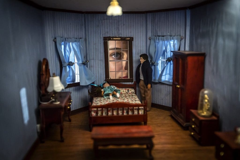 doll house with human looking through window