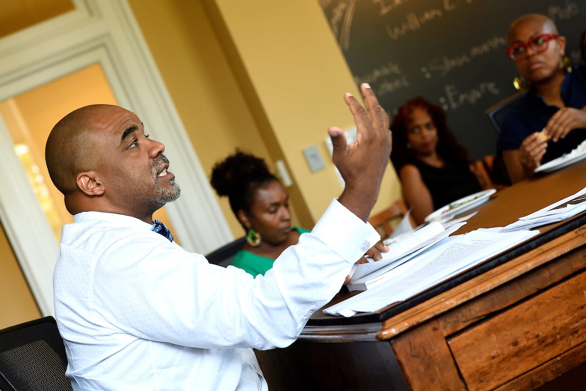 Professor Connolly talking to students gathered around a table