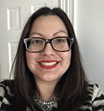 Headshot of Latina woman with glasses and red lipstick, long straight hair