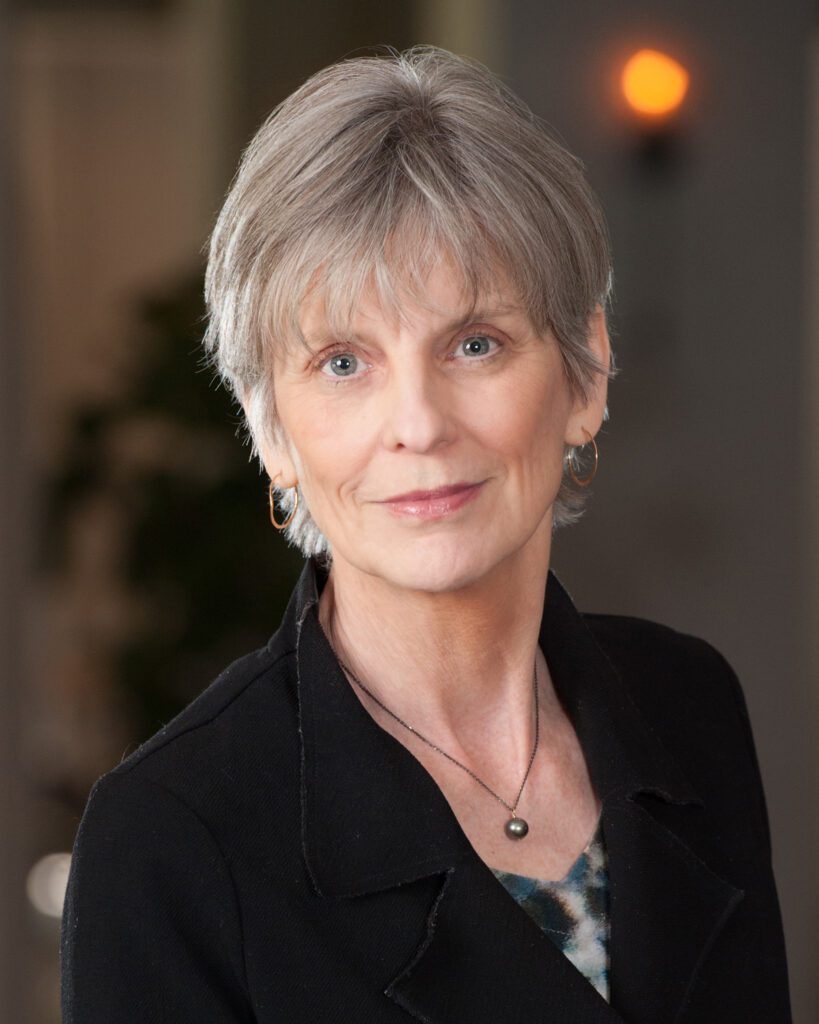 Headshot of Prof. Melani McAlister, white woman with short light hair and black shirt