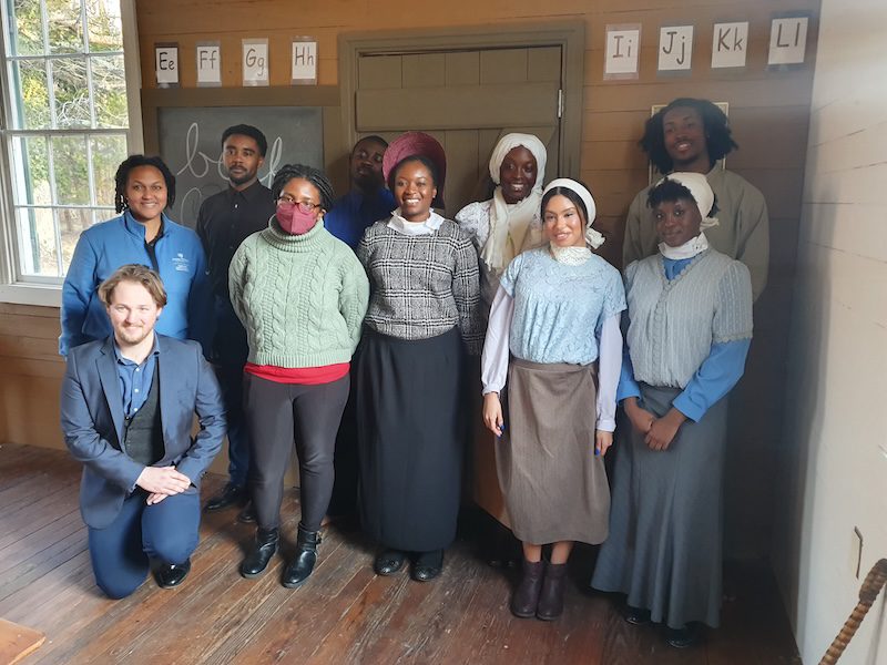 Students dressed in period costume, along with faculty