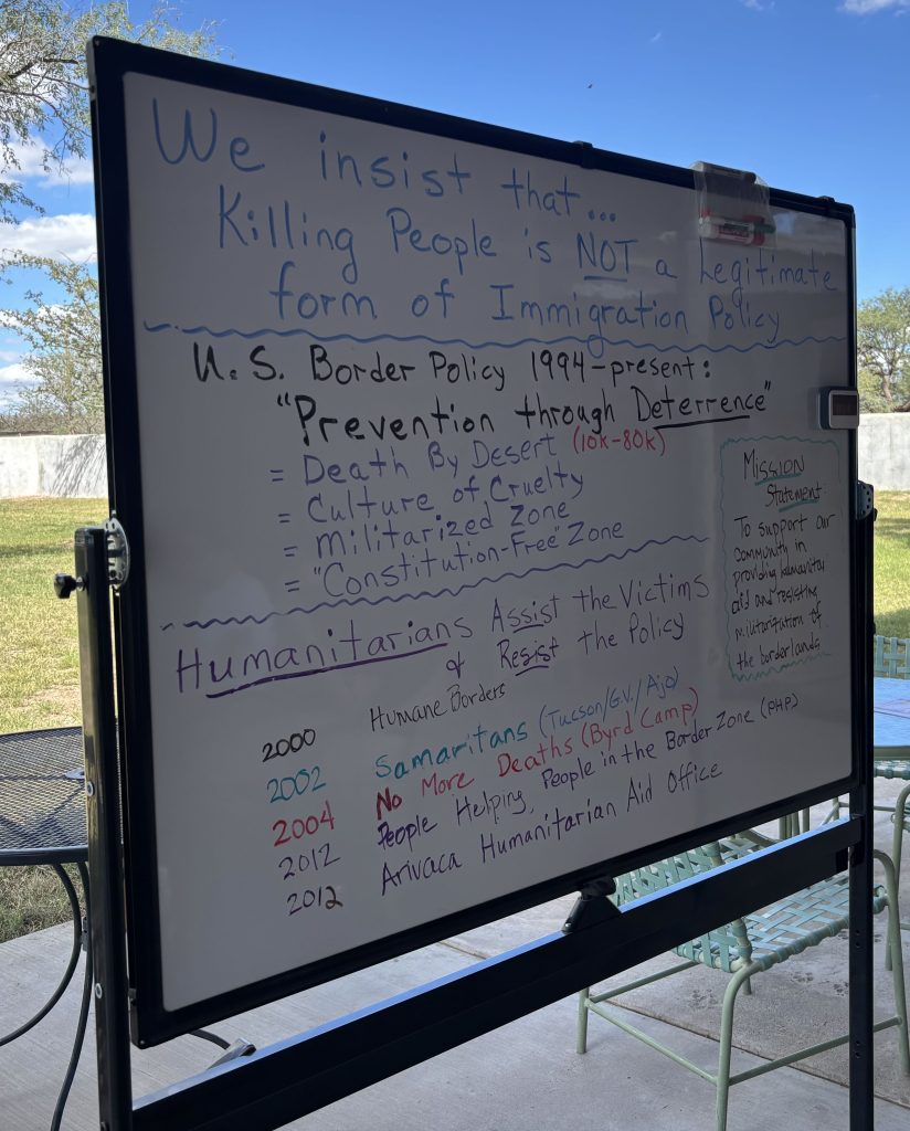 Whiteboard with history of migration control via Prevention Through Deterrence written on it.