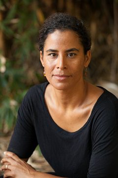 Headshot of dark-skinned woman with short hair and black shirt