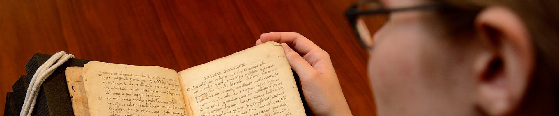 A student looks at a copy of Virgil’s works printed in Venice in 1507 that is part of the university’s rare book collection.