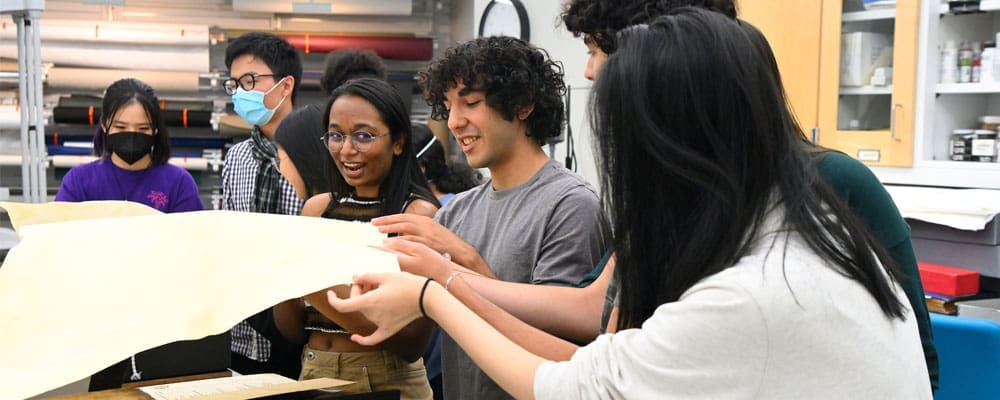 Group of students looking over old documents.