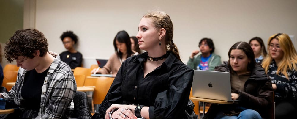 Undergraduate students listening in a classroom.