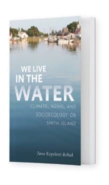 We live in the water book cover with water reaching up to houses on the shore of Smith Island