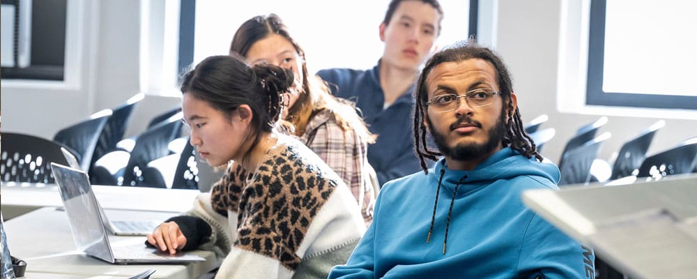 Four students listening in class.