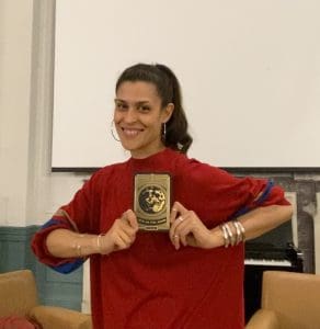 Artist Dessa holds up her new poetry collection, "Tits on the Moon."