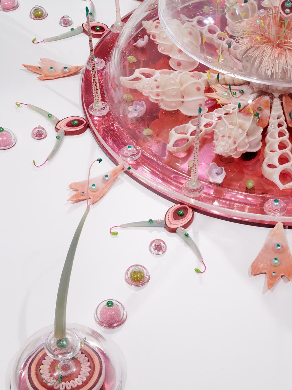Various cut and polished seashells, urchin spines, green tusks, squilla claws, butterfly wings, cut paper, colored powder pigments, colored plastic beads, acrylic domes, brass rod, colored and mirrored Plexiglas, glue, acrylic on wood.