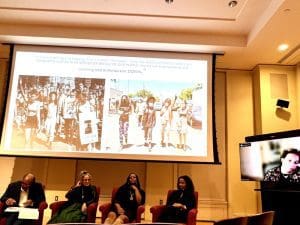 COURTESY OF JIAYI LI: Daughters of the Movement speakers onstage in front of archive images of themselves and their Civil Rights forebearers at protests.