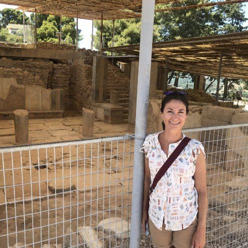 Jennifer Marks (brown-haired woman) standing in front of ancient Aegean archeological site.