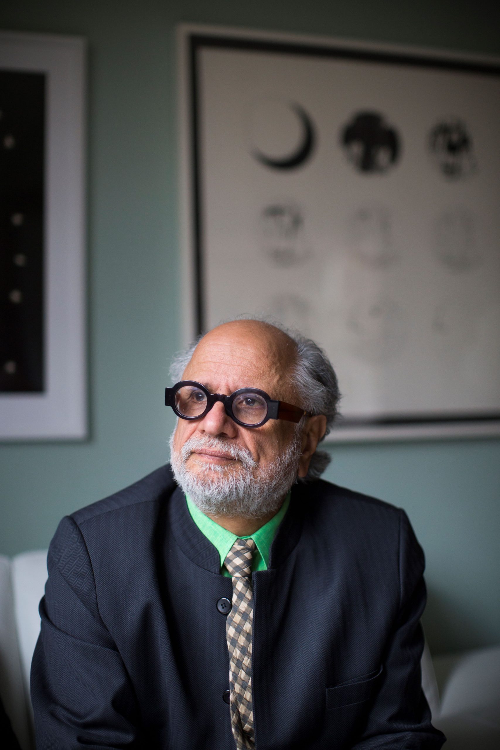 Photo of Homi Bhabha wearing black frames, looking up and wearing a dark colored sport coat