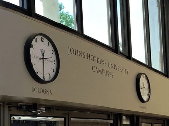 clocks in the library showing the times for all JHU campuses