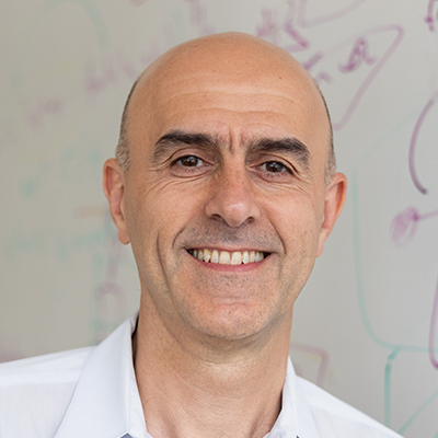 Dr. Jazayeri is facing and smiling at the camera wearing a white shirt.