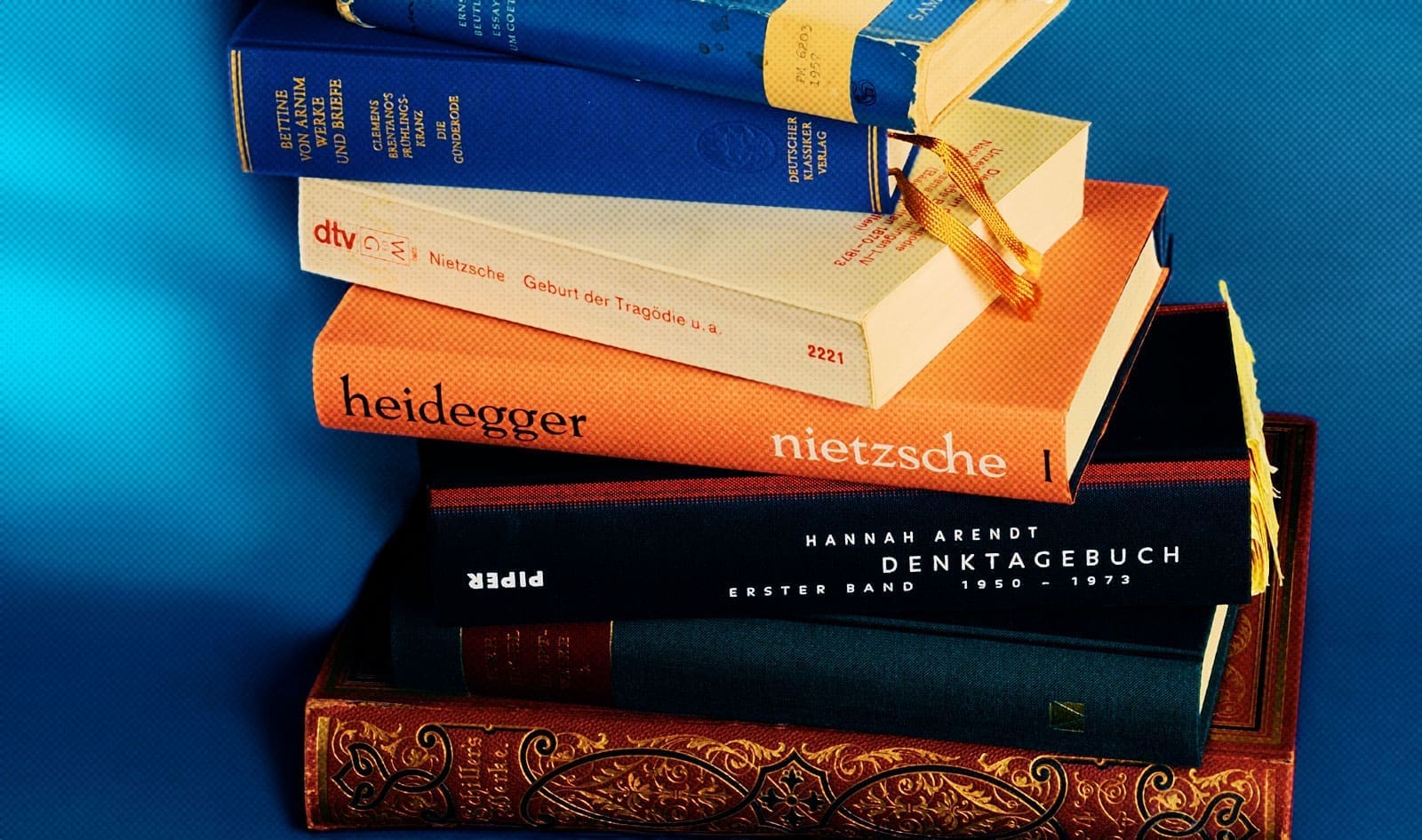 stack of books by Nietzche, Hannah Arendt, and more in German