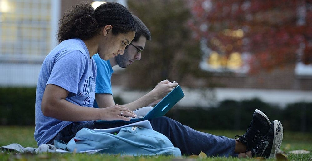 Students sitting outside studying