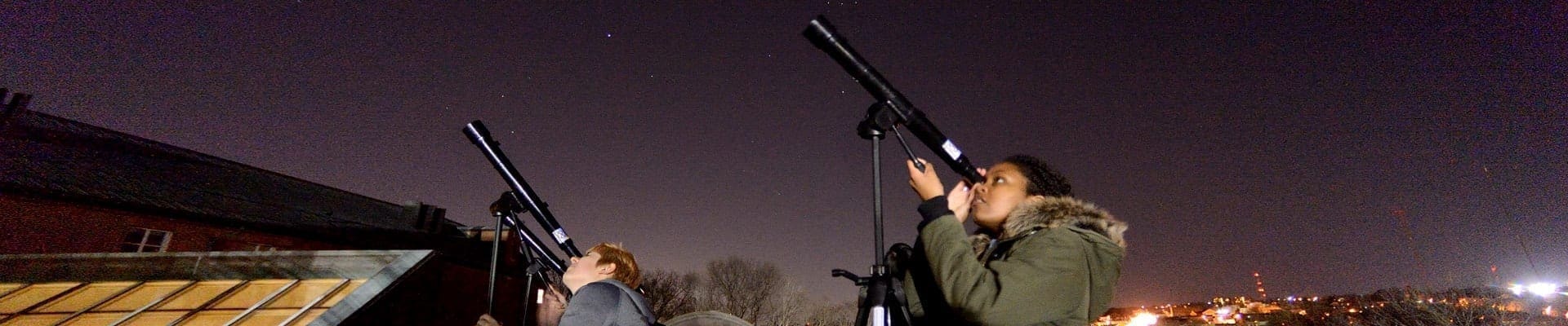 students using telescopes