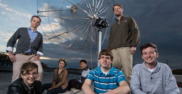 photo of Professor Tobias Marriage with undergrad students and satellite