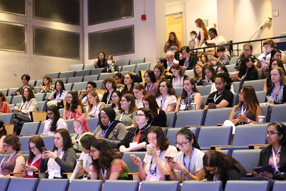 a variety of women in auditorium classroom seating at a gender minorities and women in physics event