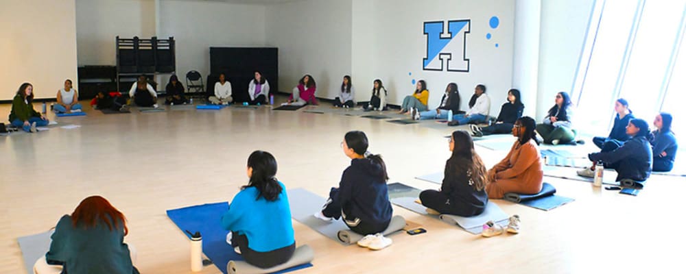 Public Health students gathered in circle for a yoga session.