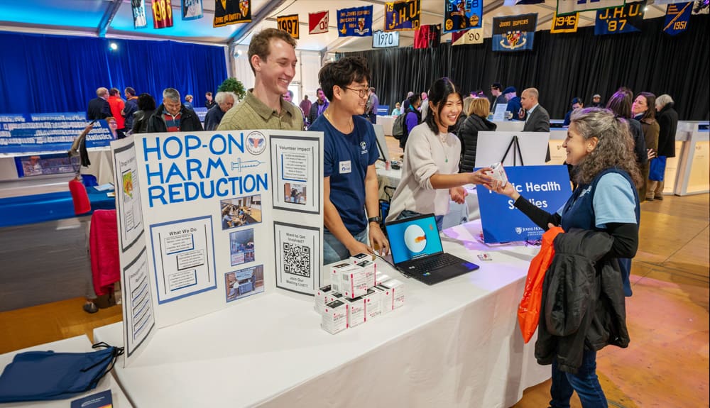 PHS students at an information table, handing out Naloxone and harm reduction materials.