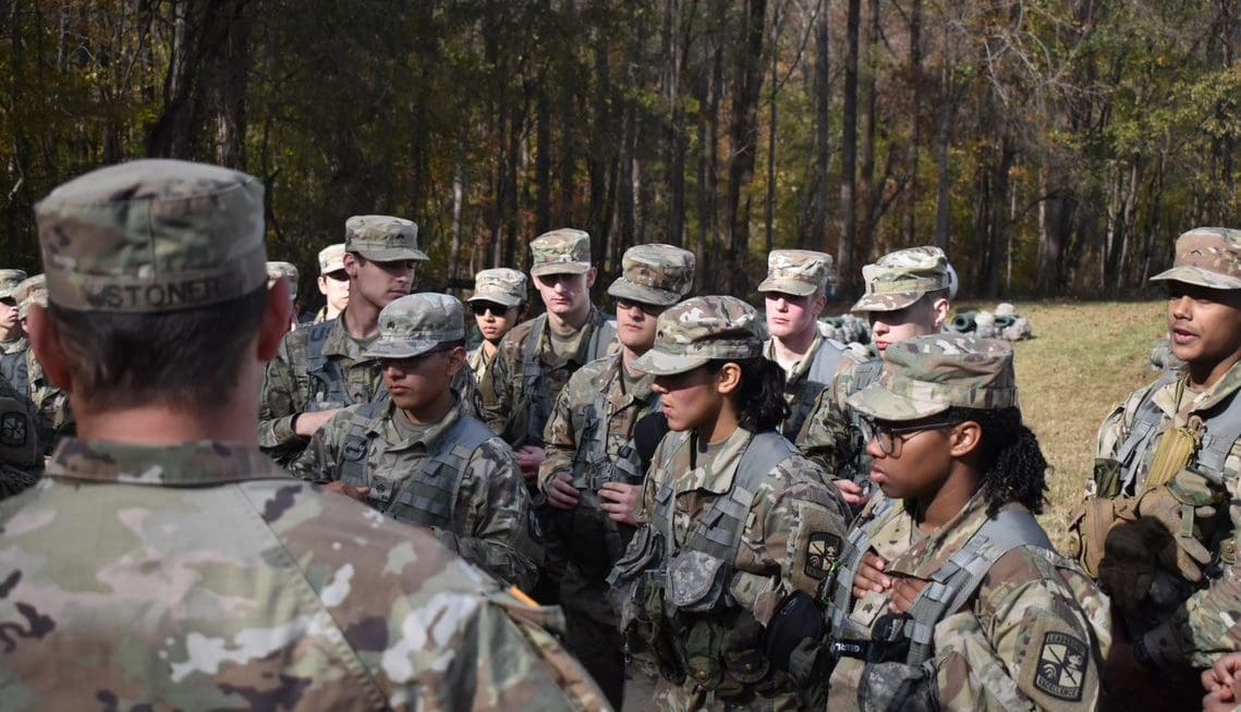 Cadets receiving instruction during field training exercise.