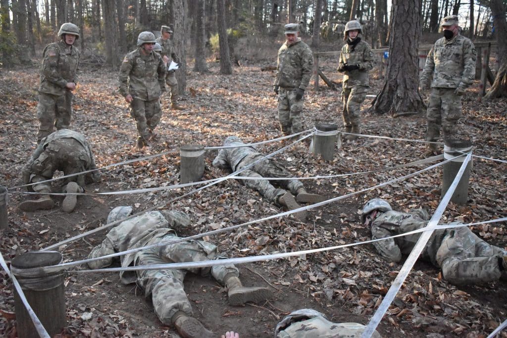 cadets crawling under rope structure 