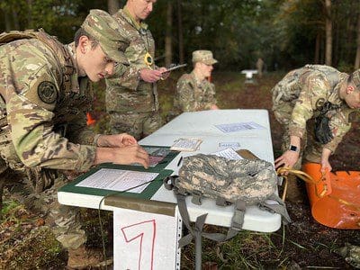 Cdt Atkinson performing land nav at the competition. 
