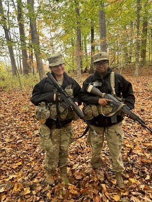 two cadets in fatigues with guns