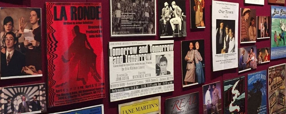 wall of posters and photos from past productions