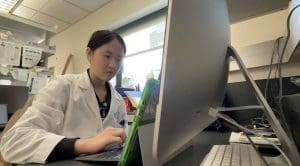 Angelina Dong works at a computer in the lab.