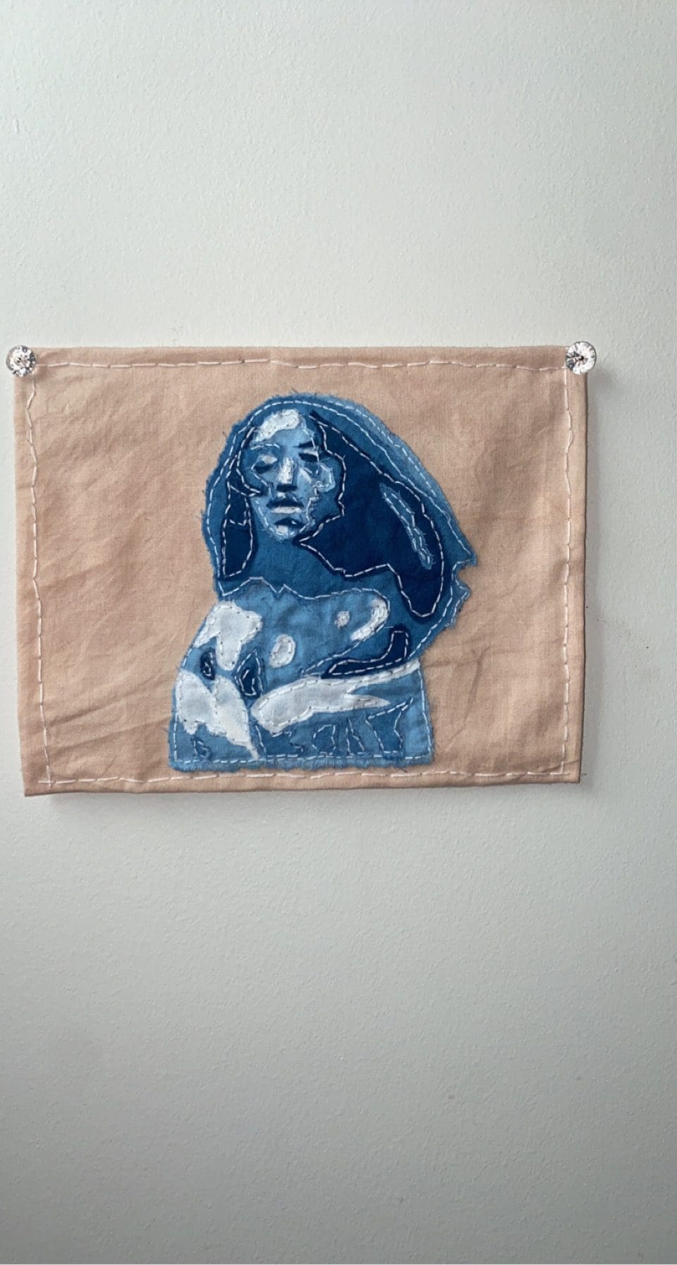 pale pink fabric with a portrait of a Black woman in indigo fabric