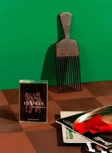 still life with a pick, a casette and some art on a wooden table