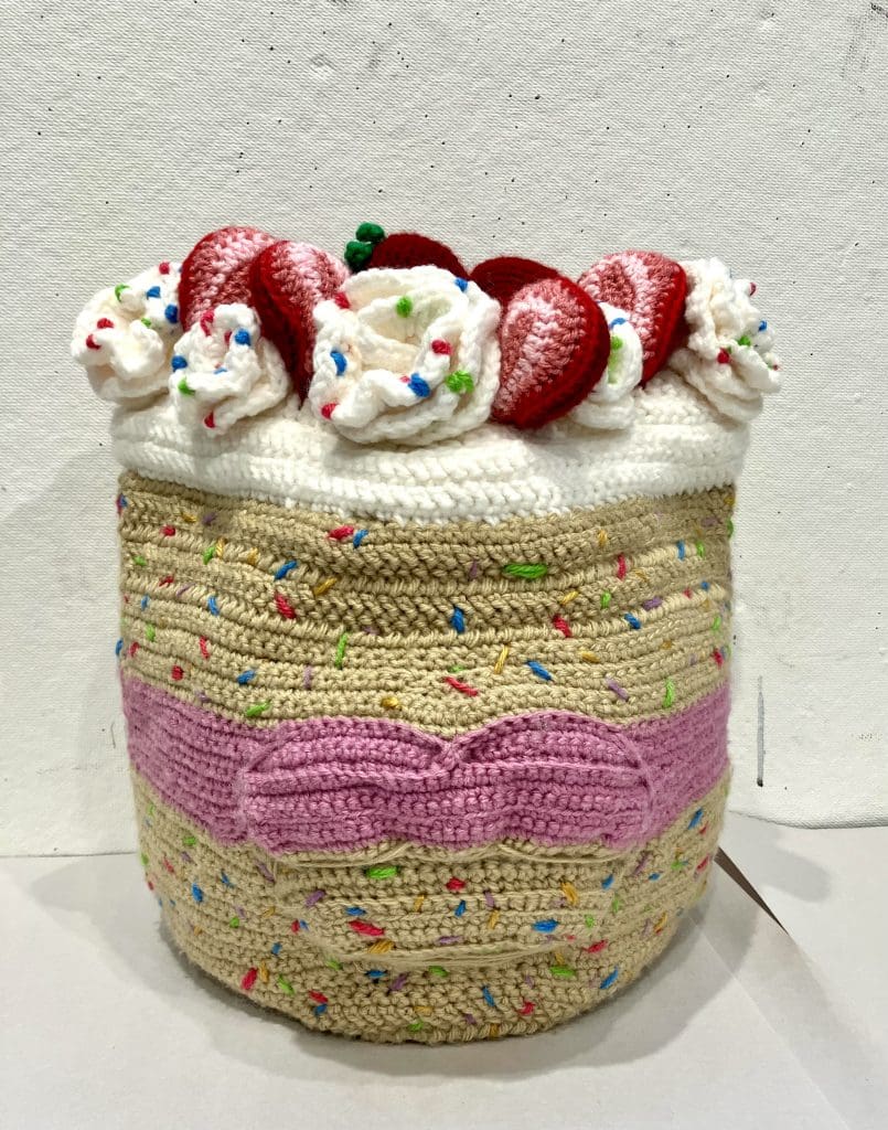 3D crochet sculpture of a strawberry cake