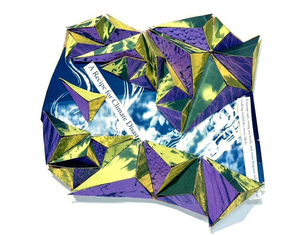 a student's 3d abstract sculpture with purple and yellow prism-like designs