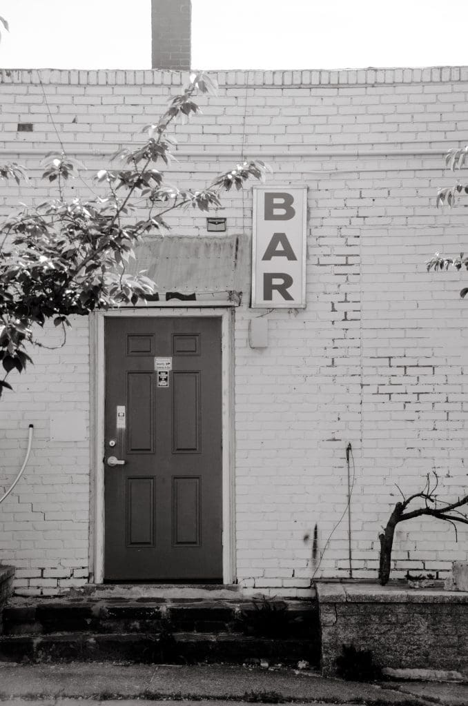 a doorway with a sign above it "bar"