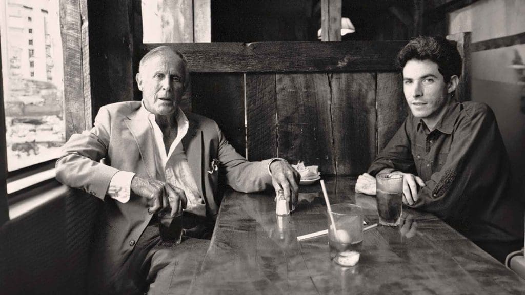 Eugene Leake and Craig Hankin sitting at a table with drinks