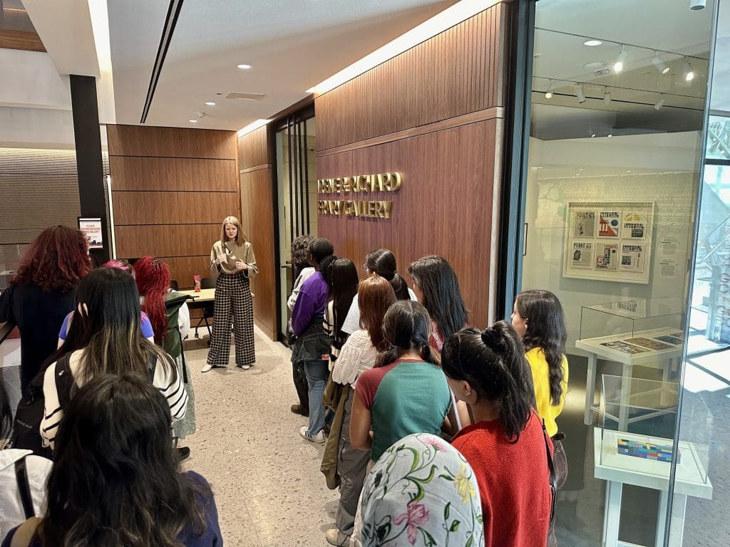 students listening to curator caitlin Berry at the Irene and Richard Frary Gallery